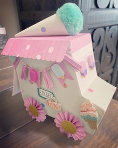 an ice cream cart is decorated with pink flowers