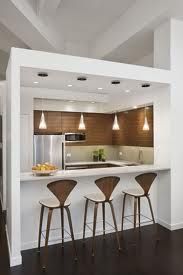 three bar stools sit in front of the kitchen counter