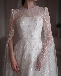 a woman in a white wedding dress and veil