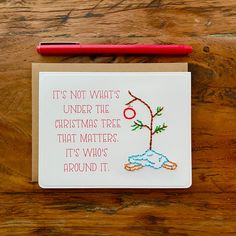 a note card with a drawing of a tree on it and a red pen next to it