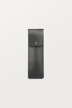 Classic and timeless BLACK PEN CASE with gold brass closure, made of high-quality sustainable (vegetable-tanned) genuine natural leather. This pen holder makes the perfect business gift for your colleagues, clients, or anyone else who appreciates quality and style. ✚ DIMENSIONS:  6 x 50,8 inch (6 x 19 cm) ✚ WHAT YOU CAN FIT IN IT: pens, pencils, crayons or markers. It will hold approx. 3-4 pens. ✚ PRODUCTION: the product is handmade entirely in Poland in our small leather craft workshop ✚ LEATHER: sustainable natural genuine vegetable- tanned leather, that has been tanned using extracts from the mimosa and quebracho trees. It comes from a Polish tannery and is stiff in texture. ✚ COLOR: black ✚ INTERIOR FINISH: suede, unlined ✚ CLOSURE: brass button studs (gold) ✚ PACKAGING: 100% eco-frien Modern Everyday Pencil Case, Modern Rectangular Pencil Case, Modern Leather Pencil Case For Daily Use, Classic Rectangular Pencil Case For Personal Use, Black Rectangular Pencil Case For Everyday Use, Modern Pencil Case With Pen Holders, Classic Leather Pencil Case For Personal Use, Modern Leather Pencil Case With Pen Slots, Black Leather Pencil Case With Pen Holders