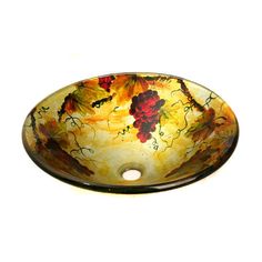 a glass sink with grapes painted on the bowl and leaves in the bottom, sitting on a white surface