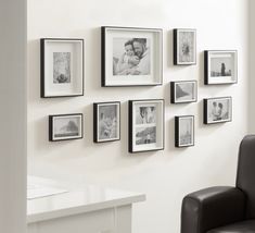 black and white photographs are hung on the wall next to a chair in front of a desk