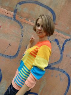 "Aesthetic hand knitted rainbow sweater with stripes and color blocks. Slightly cropped length, relaxed fit, crew neck. Jumper on the photo is presented as an example. Its color range cannot be exactly repeated! LENGTH: XS-S - about 21,5\" / 55 cm M - about 22,5\" / 57 cm L - about 23,5\" / 59 cm Can be made longer for your preferences. Here shown in size S. Model is 5'7\" / 171cm and bust 32\" / 82cm. YARN: 40% wool, 20% bamboo, 40% acrylic Each jumper is made to order. Please allow approximate Knitted Rainbow, Sweater With Stripes, Handmade Knitwear, Colorblock Sweater, Rainbow Sweater, Hand Knit Hat, Sweater For Women, Women's Beanie, Crew Neck Jumper