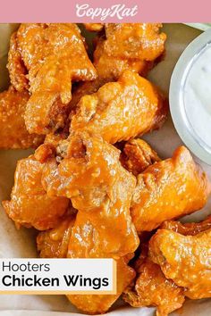 chicken wings in a basket with ranch dip and text overlay that reads copykatt hooters chicken wings