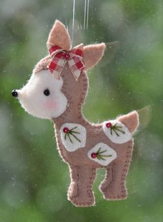 a stuffed deer ornament hanging from a window