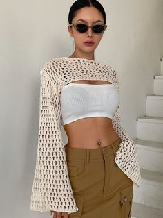 a woman wearing sunglasses and a crop top