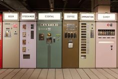 a row of vending machines sitting next to each other on top of a wooden floor