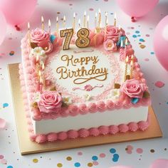 a birthday cake with pink roses and candles