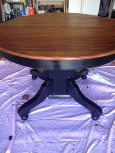 a wooden table sitting on top of a purple sheet