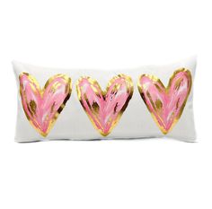 three pink and gold hearts on a white pillow