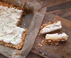 two pieces of cake sitting on top of a wooden cutting board