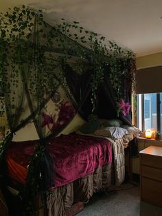 a bed sitting next to a window in a room with plants growing on the wall