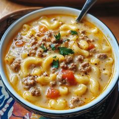 a bowl filled with pasta and meat soup