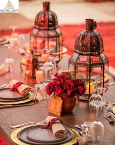 a wooden table topped with lots of place settings