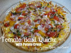 tomato basil quiche with potato crust in a glass pie dish on a marble countertop