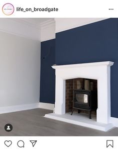 a room with a fireplace and blue walls