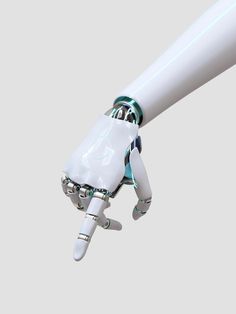 a robotic hand holding a white object in the air