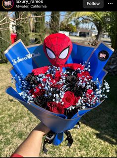 someone holding a bouquet of flowers with a spider - man face on the front and side