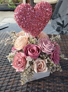 a vase filled with lots of flowers on top of a table