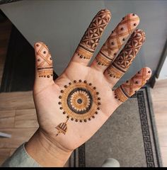 a person's hand with hendi designs on it