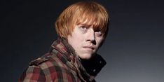 a young man with red hair wearing a plaid jacket and looking off to the side