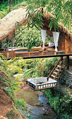 an outdoor area with a thatched roof and steps leading up to it