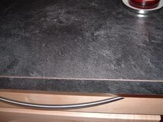 a black counter top with a candle on it