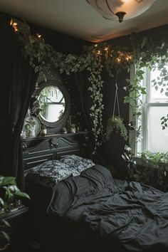 a bedroom with black walls and plants on the window sill, bed in foreground