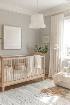 a baby's room with a crib, chair and rug