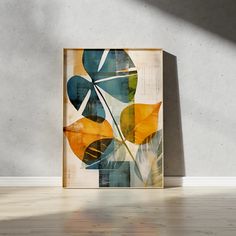 an abstract painting on the wall in front of a white wall with a wooden frame