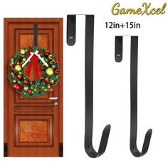 the door is decorated with a christmas wreath and two black handles, which are attached to it