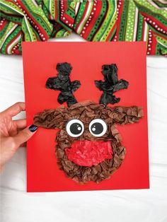 a handmade christmas card with a reindeer's face made out of brown paper