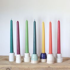 seven candles are lined up in different colors