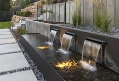 an outdoor water feature with rocks and plants