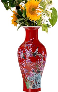 a red vase filled with lots of different types of flowers