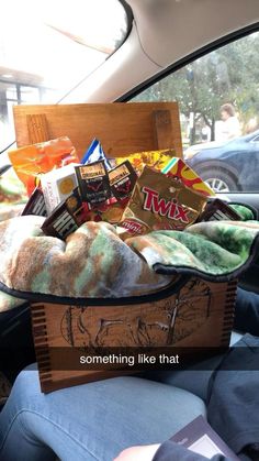 a basket filled with food sitting in the back seat of a car