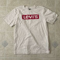 New Without Tags Levi’s Tee Shirt. Never Washed Or Worn Levi's White Short Sleeve Shirt, Levi's White Cotton Top, Levi's White Relaxed Fit Shirt, Casual White Levi's Top, White Cotton Levi's Top, Levi's Red Crew Neck Top, Levi's White Relaxed Fit Top, Levi's White Graphic Tee, Levi's White Cotton Shirt