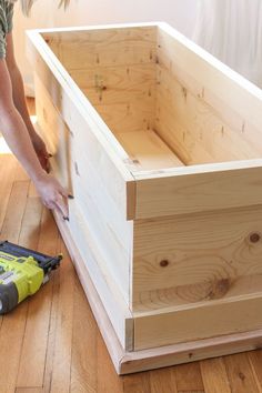 a person is working on a wooden box