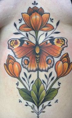 a woman's stomach with an orange flower and butterfly tattoo on it