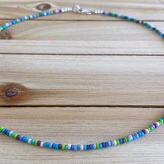 This vibrant choker is a playful combination of blues and purples with a splash of pink and green for an added touch of color. All chokers are customizable to the size you need so please be sure to measure your neck where you want your choker to sit and order accordingly! This high quality beaded choker is beautiful worn on its own or layered. It is finished with sterling silver accents, secured with a sterling silver lobster claw and made with glass beads that can stand the test of time, making Adjustable Purple Choker With Colorful Beads, Blue Bead Choker For Beach, Blue Beads Choker For Beach, Summer Purple Beaded Necklaces With Colorful Beads, Summer Purple Beaded Necklace With Colorful Beads, Handmade Purple Beaded Necklaces For Beach, Blue Round Beads Choker For Beach, Purple Tiny Beads Necklace For The Beach, Purple Tiny Beads Necklace For Beach