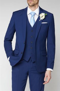 a man in a blue suit with a flower on his lapel