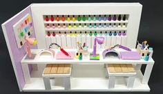 a dollhouse desk with lots of crafting supplies on it's sides and shelves