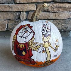 a pumpkin decorated with cartoon characters painted on it