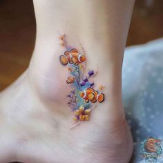 the foot is decorated with colorful flowers and fish