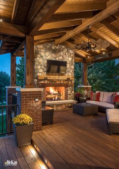 an outdoor living area with fireplace and seating