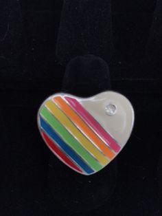 This is a necklace that emanates joy! I love the 1980s, hearts, and rainbows...so I'm on the lookout for pieces that combine all three of those elements and this was a rare find! There are very few of the authentic 80s rainbow jewelry pieces left these days. This ring has an adjustable band, so should fit most sizes! Please inspect the photographs thoroughly as this is a vintage item, which means often times the item is not perfect due to usage, and I do not offer refunds based on flaws that are Multicolor Heart-shaped Ring For Gift, Multicolor Retro Jewelry For Gift, Valentine's Day Multicolor Ring Jewelry, Multicolor Heart-shaped Anniversary Ring, Rainbow Jewelry For Valentine's Day Gift, Multicolor Ring Jewelry For Valentine's Day, Vintage Multicolor Jewelry For Valentine's Day, Multicolor Heart Charm Jewelry For Anniversary, Rainbow Retro Jewelry For Gift