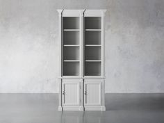 a tall white bookcase with two doors on the front and one door open to reveal an empty space