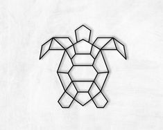 a black and white image of a turtle made out of geometric shapes on a wall