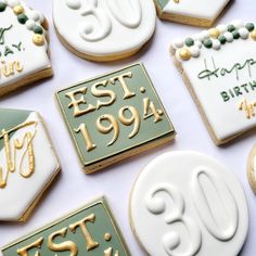 decorated cookies are arranged on a table for an 80th birthday party or anniversary celebration